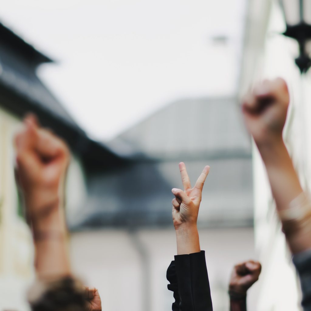 People holding up peace signs